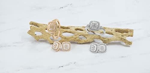 Elegant diamond rings displayed on a natural textured surface.