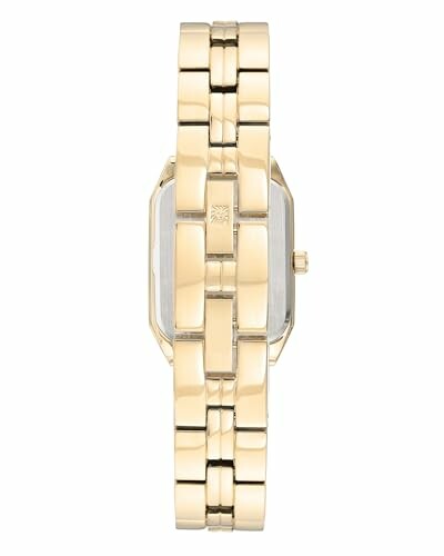 Side view of a gold watch bracelet with a rectangular face