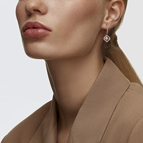 Woman wearing earrings with a neutral outfit.